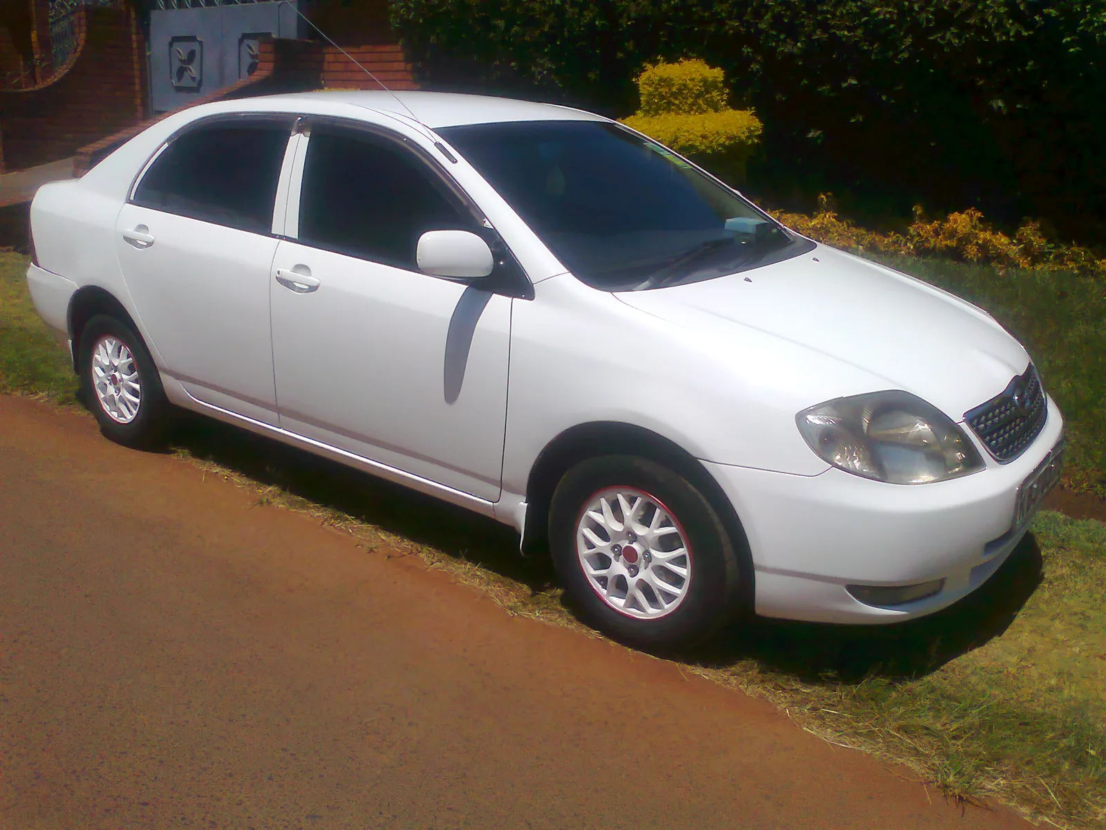 White Toyota Corolla saloon, front three quarter